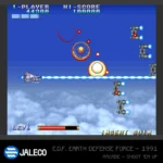 Retro arcade shooter: player ship on the left fires a blue laser at enemy units across a blue sky.
