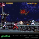 Arcade fighting game scene: a muscular fighter on a metal platform in a space backdrop, clashing with two blue/white-clad enemies as explosions occur nearby.