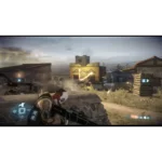 First-person shooter battlefield in a dusty desert town; player aims a rifle amid explosions and smoke.
