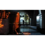 Dim interior scene with orange lighting, crates and a person crouching in the foreground, looking toward a sunlit arched courtyard with palm trees outside; bottom displays 'FIRST LIGHT' poster text.