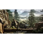 Person crawls over a rocky ledge in a pine forest with snow-capped mountains in the distance, a facility visible in the valley, and 'First Light' text at the bottom.