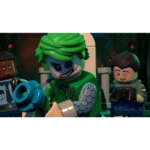 LEGO Joker minifigure with green hair and a scarred grin aims a blue blaster as two other LEGO figures look on in a dark corridor