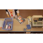 Overhead view of a checkout counter with a blue grocery basket, canned goods, a packaged item, and a yellow cash register on the right.