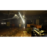 First-person shooter scene: player aims a rifle in a dim, cluttered office with sparks flying from a damaged ceiling.