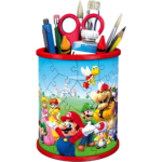 Blue pencil holder with a red rim filled with pens, markers, scissors and brushes; the cup features a Mario‑and‑friends puzzle design on its side.