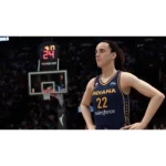 Female basketball player wearing Indiana jersey #22 stands with hands on hips on the court during a game in a crowded arena.