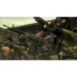 Group of soldiers in tactical gear aiming assault rifles in a combat stance, indoors at a warehouse-like location.