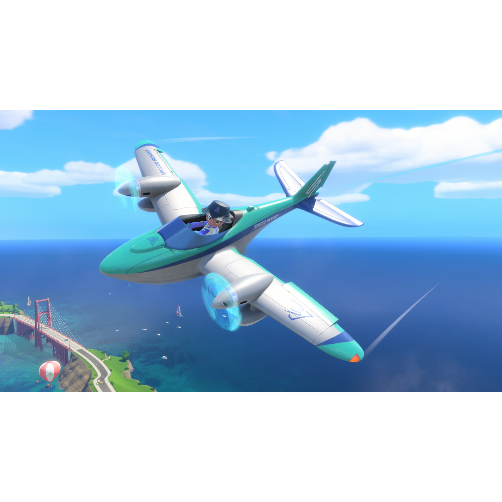 Green and white seaplane in flight over blue ocean near a coastline with a red suspension bridge below on a sunny day.