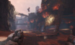 Warhammer_PS5_Screen_05__271351777584812 - Video Game Depot Desolate canyon filled with rusted industrial ruins, crumbling towers, and glowing orange fires at dusk.