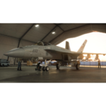 db75487e-e74e-4d90-a1b6-c7d3b369be81__031051781184908 - Video Game Depot Military fighter jet labeled 203 inside a large hangar, technicians inspecting the nose landing gear nearby.
