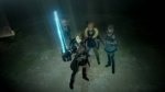 efe0dcb2-1e2a-456f-861f-2a35c0722543 - Video Game Depot Female warrior in front wields a glowing blue sword, flanked by three companions in a dim stone corridor (video game scene).