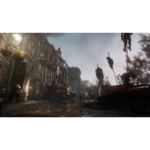 f069da6a-cd1b-4e50-8ef6-b62064b8d2eb__583471781638979 - Video Game Depot Deserted, war-torn city street with ornate buildings, debris on the ground, and some figures standing in the distance near a streetlamp. Tall poles with hanging figures rise on the right.