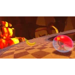 Cartoon platform game scene: a small character inside a pink/red bubble on a curved checkered path, with scattered banana peels and a lava-filled background.