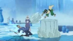 Man in blue kneels on icy ground while a green-clad fighter launches from a towering ice pillar inside a frozen cavern.