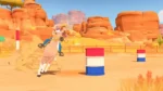 61GikqIUP9L_SL1500 - Video Game Depot Girl riding a horse as it jumps over a striped red, white, and blue barrel in a desert arena with orange rock formations.
