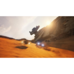 Futuristic hovercars racing across a desert at sunset, with a tilted, destroyed spaceship embedded in a rocky cliff behind them.