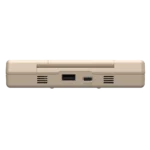 C64Image7 - Video Game Depot Underside of a beige retro laptop showing an I/O port, USB-C/Power area, and ventilation grills.