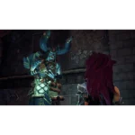Blue, horned dragon-like warrior in teal armor raises arms in a dim dungeon while a person with red hair watches from the foreground.