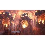 Inside a volcanic cavern lit by glowing orange lava, with jagged rocks and a lone explorer in protective gear.