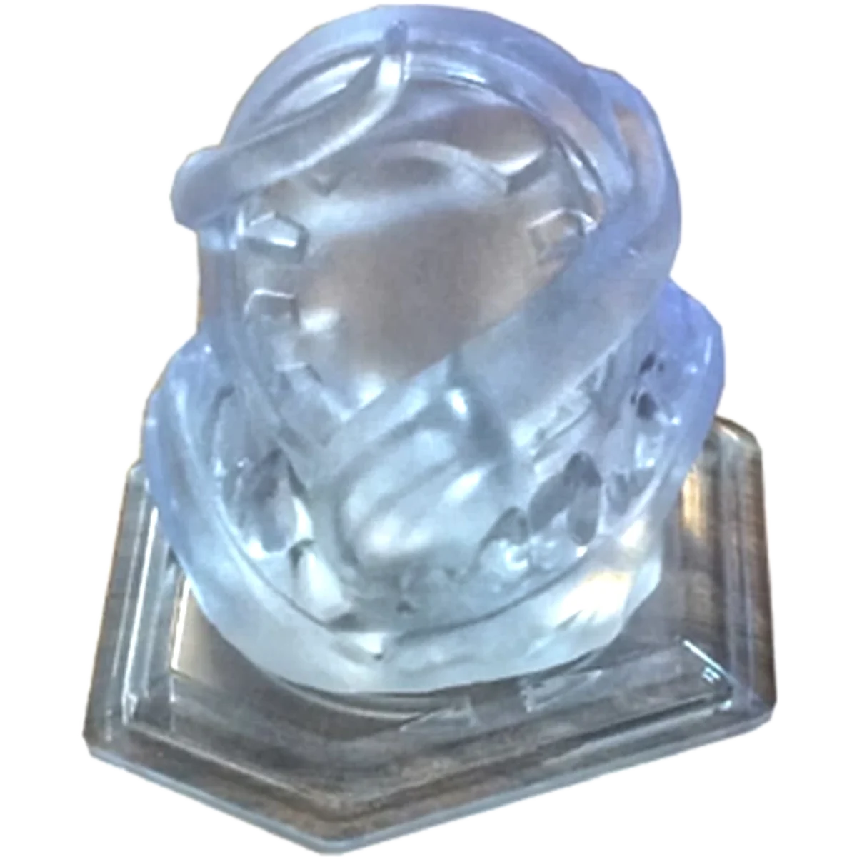 Crystal glass bust sculpture of a head and shoulders with a scarf, mounted on a square wooden base/stand.