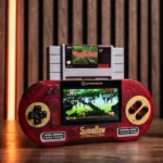 Red handheld game console with a Jungle Book cartridge resting on top, displaying a forest scene on the screen and 'Supaboy' branding on the body.