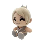 Soft plush doll of a cute, smiling character with short blonde hair, wearing a gray outfit and small crown, sitting cross-legged.