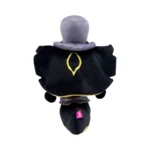 Back view of a plush toy wearing a black cape with gold trim and a purple collar, seen from behind, with a purple hat.