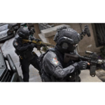 Two heavily armed tactical officers in black armor move through a stairwell, one aiming a rifle with a scope at the front.