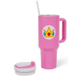 Pink insulated tumbler with a straw and a crown sticker on the front; lid and matching cap are placed nearby.
