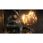 Military soldier in tactical gear holds a rifle as flames erupt behind him in a smoky urban street backdrop.