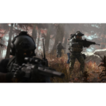 Soldiers in tactical gear advancing through a forest battlefield with rifles drawn.