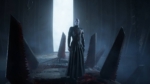 f9f15877-4121-41a2-b045-d800030c9d2f - Video Game Depot Pale humanoid in black robes stands in a dark chamber with tall serrated pillars and a bright doorway behind.