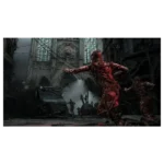 Bloody red zombie lunges in a ruined city street, with a damaged vehicle and a Gothic church in the background.