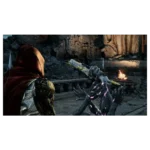 A armored warrior in a red cloak confronts a dark, glowing monster with a spiked arm in a ruined, torch-lit setting.