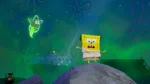 SpongeBob stands on a rock with arms outstretched as a glowing green ghost floats nearby in a green underwater scene.